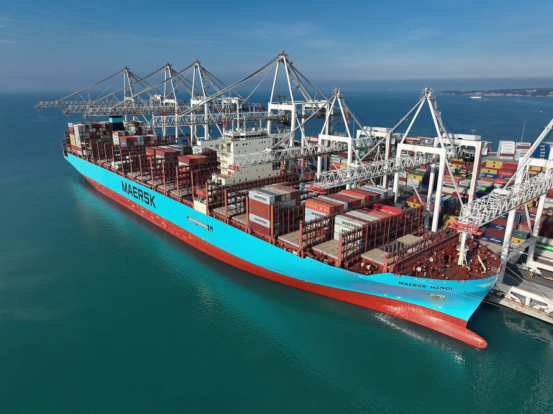 Container ship alongside cranes at port
